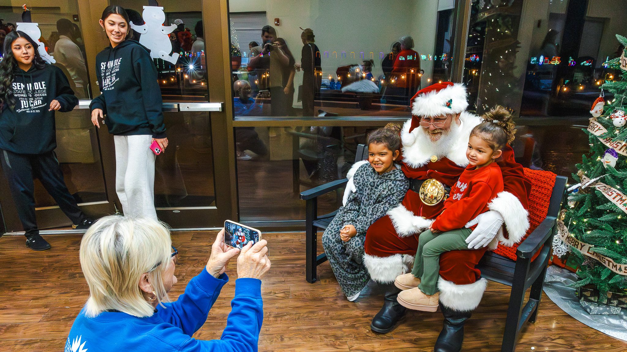 In this photo, Night at the Lights attendees line up to visit with Santa Claus and pose for festive photos.