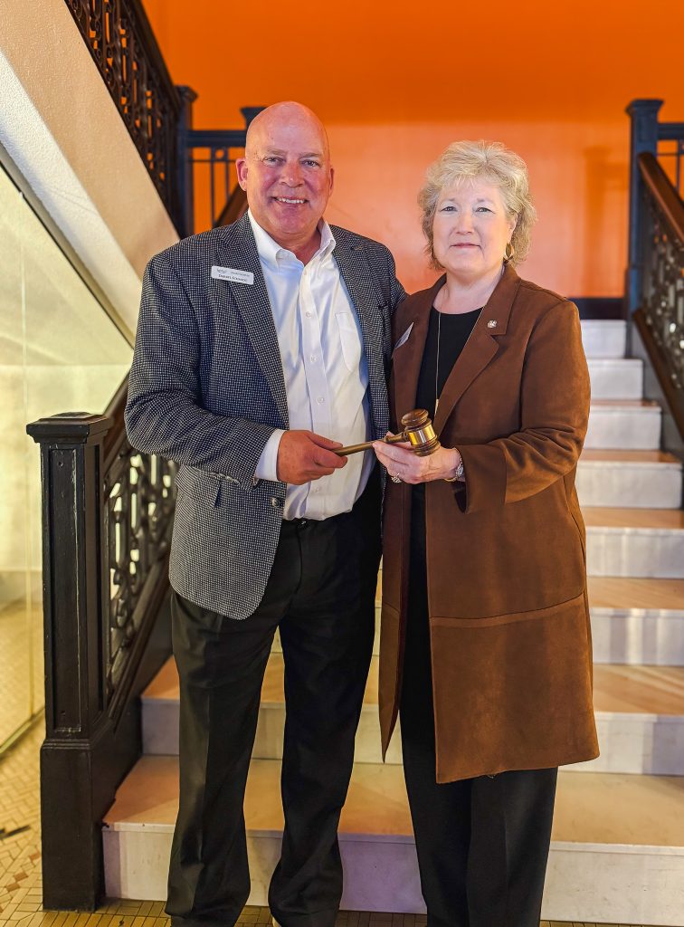 BancFirst President and CEO Darryl Schmidt (left) passes the gavel to Seminole State College President Lana Reynolds (right) as Reynolds assumes the role of 2026 Oklahoma Academy chair during the Academy’s annual business meeting Jan. 16 in Oklahoma City.
