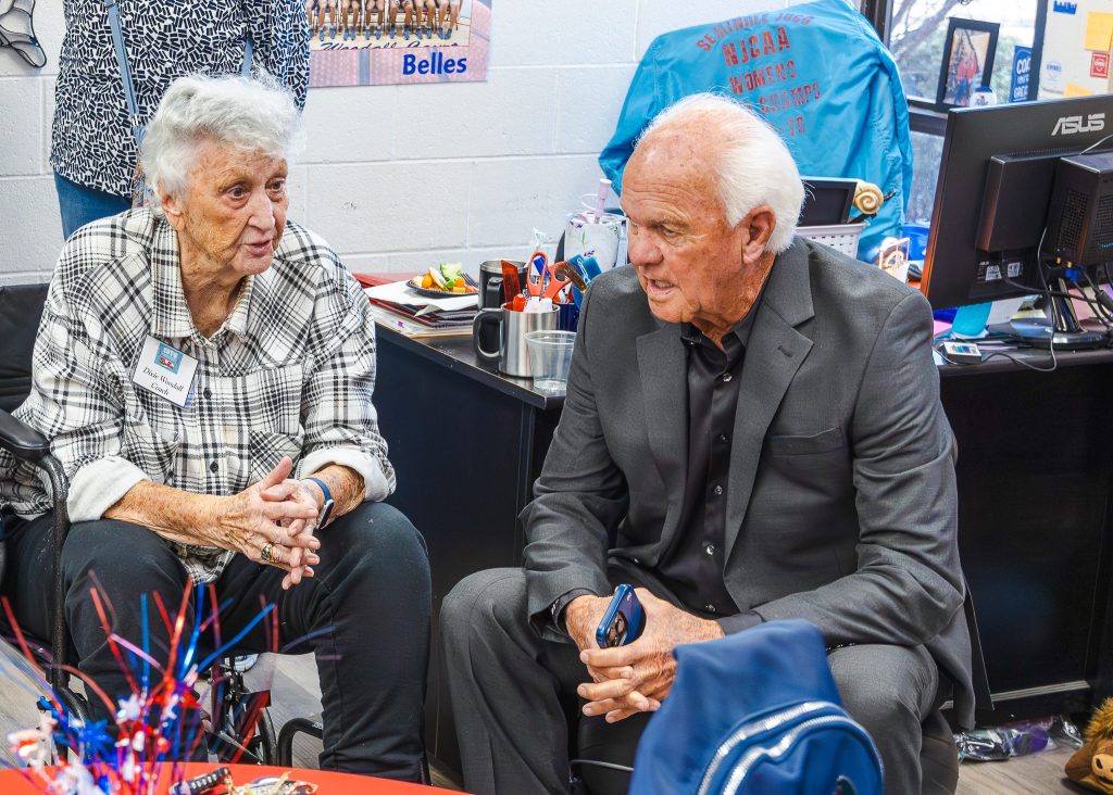 In this photo, former Seminole Junior College Belles Head Coach Dixie Woodall visits with former Baseball Head Coach Lloyd Simmons at a reception prior to the 50th anniversary celebration.