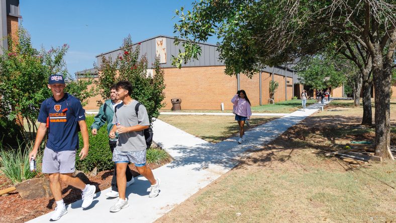 Students walk on the sidewalk on SSC's campus.