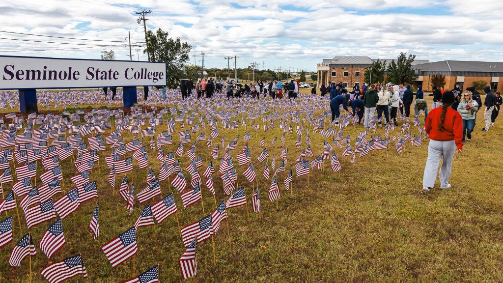In this photo, Seminole State College students plant flags on campus ahead of SSC’s third annual Military and Veteran Resource Fair in November 2025.