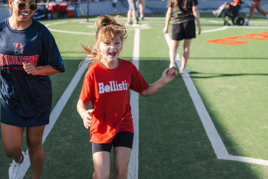In this photo, A League of Their Own player Calloway Goodwin is all smiles after a big hit on Monday, April 27. Her partner for the evening was SSC soccer player Delilah Rico.
