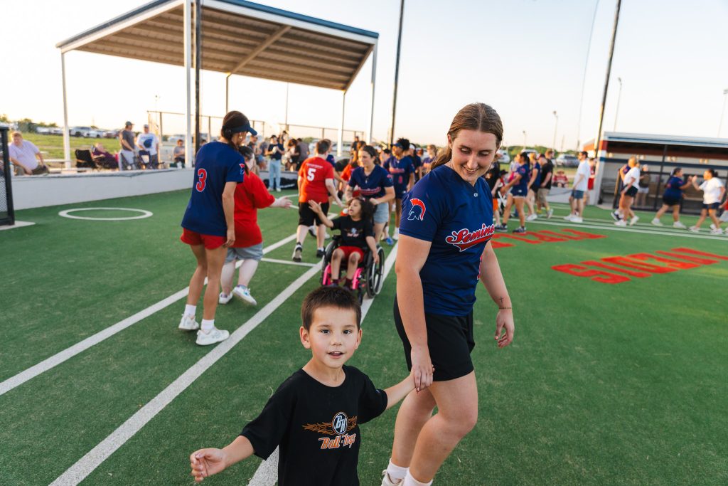 In this photo, A League of Their Own player Kylan Harjo and SSC softball player Jordyn Moody shake hands with the other team following their matchup.