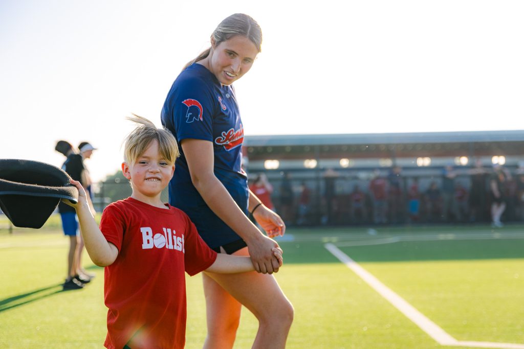In this photo, A League of Their Own player Lincoln Holleman waves his cowboy hat after rounding second base on Monday, April 27. His partner for the evening was SSC softball player Juliana Linares