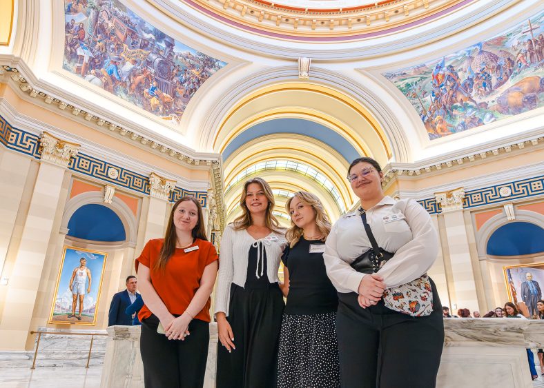 Four SSC Students pose in the atrium of the State Capitol.