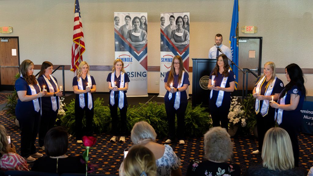In this photo, Students graduating from the program light candles during the pinning ceremony (pictured left to right) are: Whitney Zuck, Ashley Thompson, Shelbie Stephens, Riley Smith, Amanda Smith, Brittany Snolis-Hernandez, Maranda Green and Tabitha Dandridge.