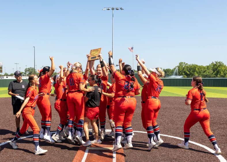 In this photo, the Seminole State College Softball team hoist their trophy after winning the district championship.