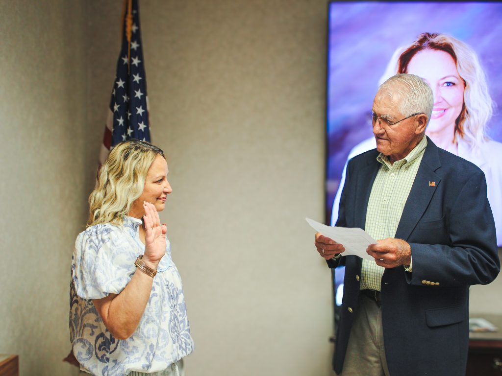 In this photo, Former State Senator Harry Coates administers the oath of office to his wife, Haley Coates, during the SSC Board of Regents meeting on May 21.
