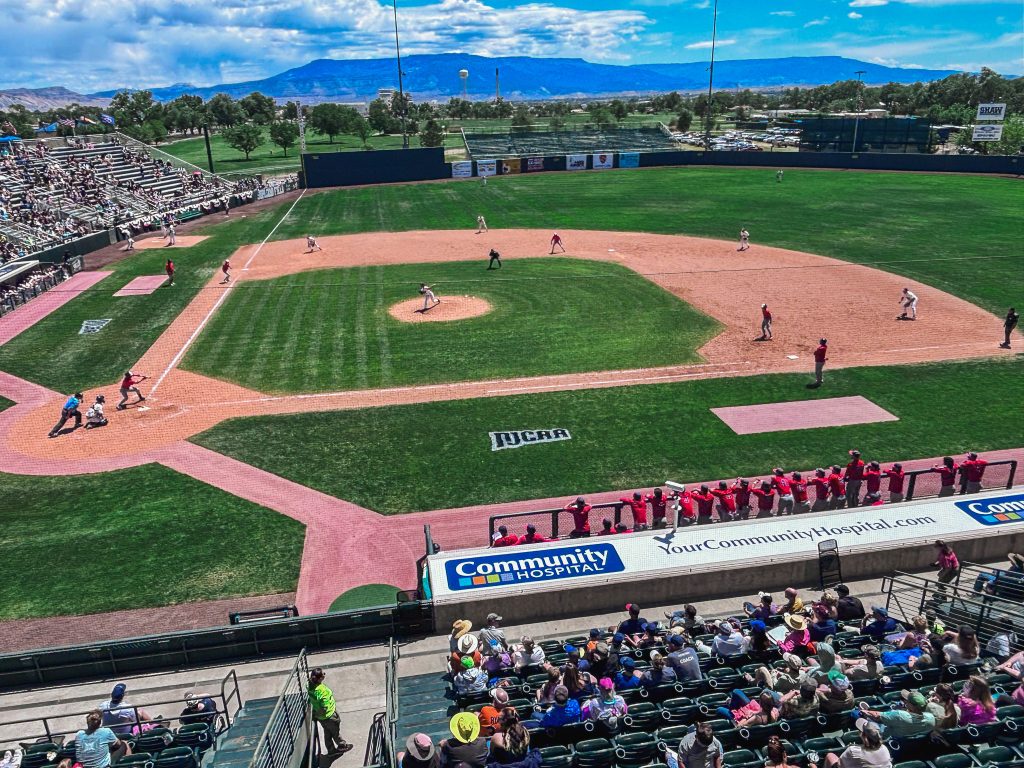 The following photo shows an elevated view of Trojan baseball team as they compete during the JUCO world series.