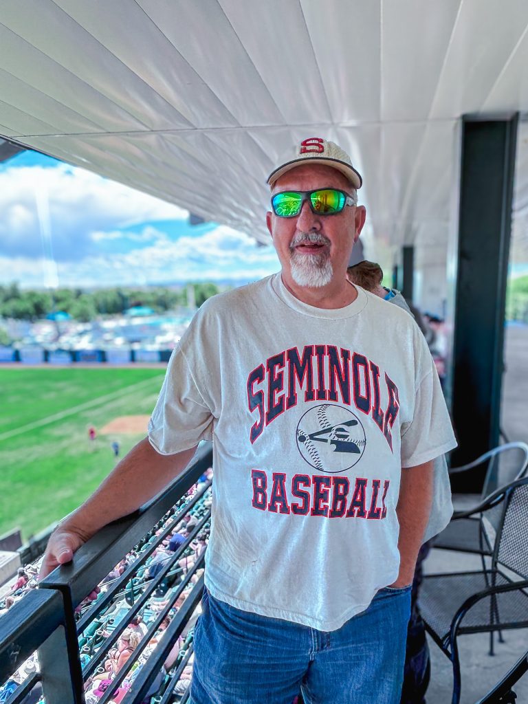 In this photo, A Grand Junction, Colorado, resident poses for a photo as he attends the JUCO World Series wearing SSC gear he received from the team years ago.