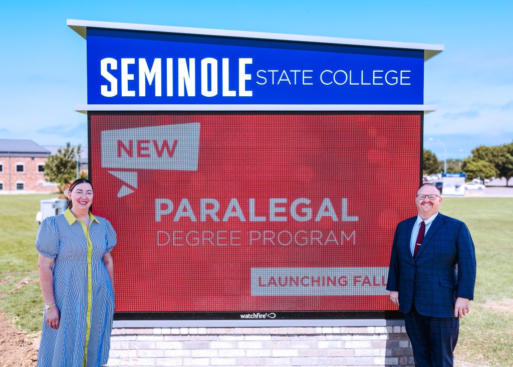 In this photo, Former Seminole State College Regent Ryan Pitts and his wife Hillary stand beside the College’s new 9-foot by 10-foot, 3-inch LED video sign on campus.