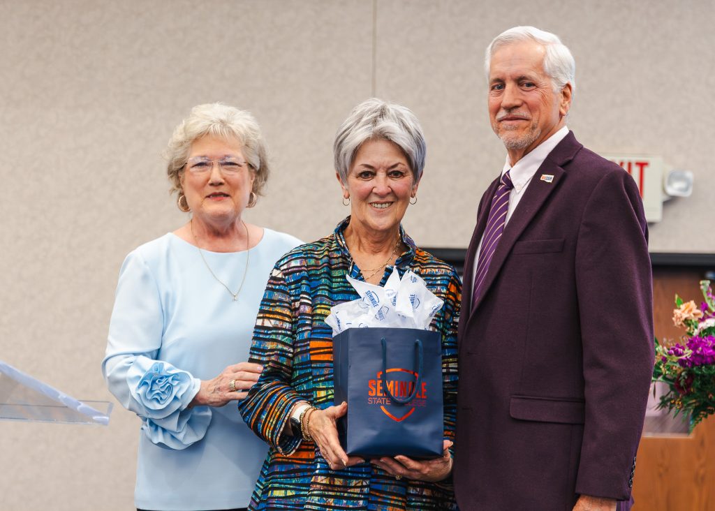 In this photo, SSC President Lana Reynolds (left) and SSC Educational Foundation Chair Mark Schell (right) present SSC Board of Regents Chair Marci Donaho (center) with a gift during the banquet. Donaho, the longest-serving regent in the history of the College, will complete her term June 30 after 21 years of service.