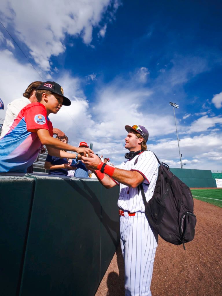 In this photo, WT Jones of Texarkana, Texas, signs an autograph for a young fan prior to the Trojans’ game against Harford Community College.