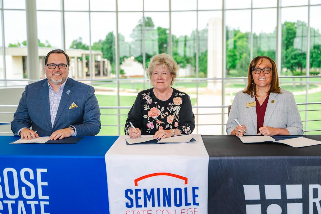 In this photo, Rose State College President Travis Hurst, Seminole State College President Lana Reynolds and Redlands Community College President Jena Marr sign a memorandum of understanding June 2 at Rose State College. The agreement allows the three institutions to share professional library services beginning July 1, 2026.