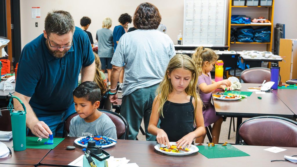 In this photo, SSC Assistant Professor of Mathematics Cullen Birney assists campers with planning, design and architecture concepts through LEGO building activities.