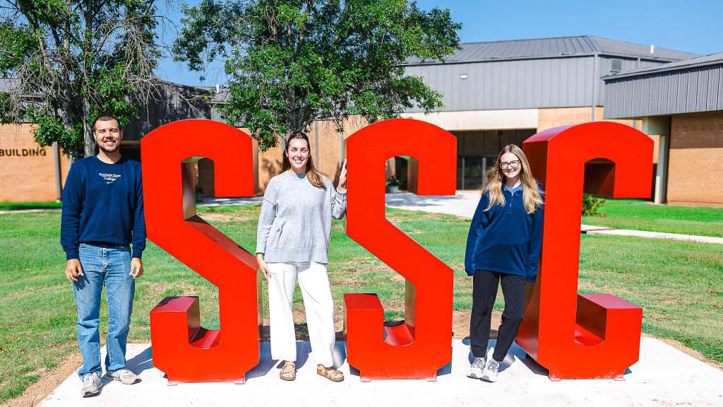 In this photo, pictured from left, Academic Advisor Davis Kappele, Recruitment Specialist Maddy Potter and Financial Assistance Specialist Lauryn Flewallen pose with the new SSC block letters recently installed on campus.