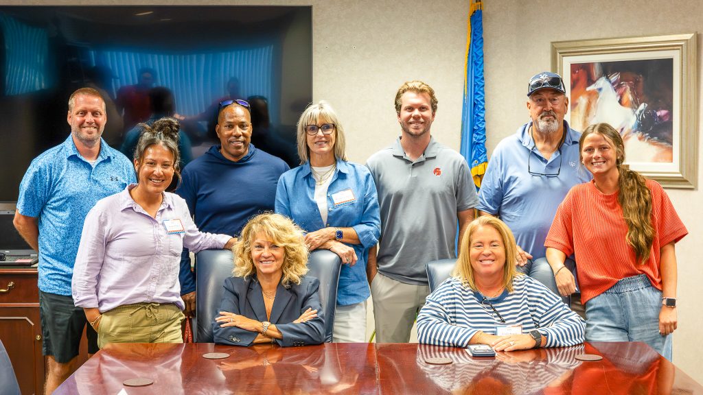 In this photo, Former University of Oklahoma Women’s Basketball Head Coach Sherri Coale poses for a picture with Seminole State College coaches and athletics staff following her Aug. 12 keynote at SSC’s fall in-service. Pictured from left are Women’s Soccer Head Coach Dan Hill, Softball Head Coach Amber Flores, Baseball Head Coach Mack Chambers, Coale, Women’s Basketball Head Coach Rita Story-Schell, Men’s Basketball Head Coach Austin Bogle, Athletic Director Leslie Sewell, Golf and Cross-Country Head Coach Ronnie Williamson and Volleyball Head Coach Bobbi Leitha.