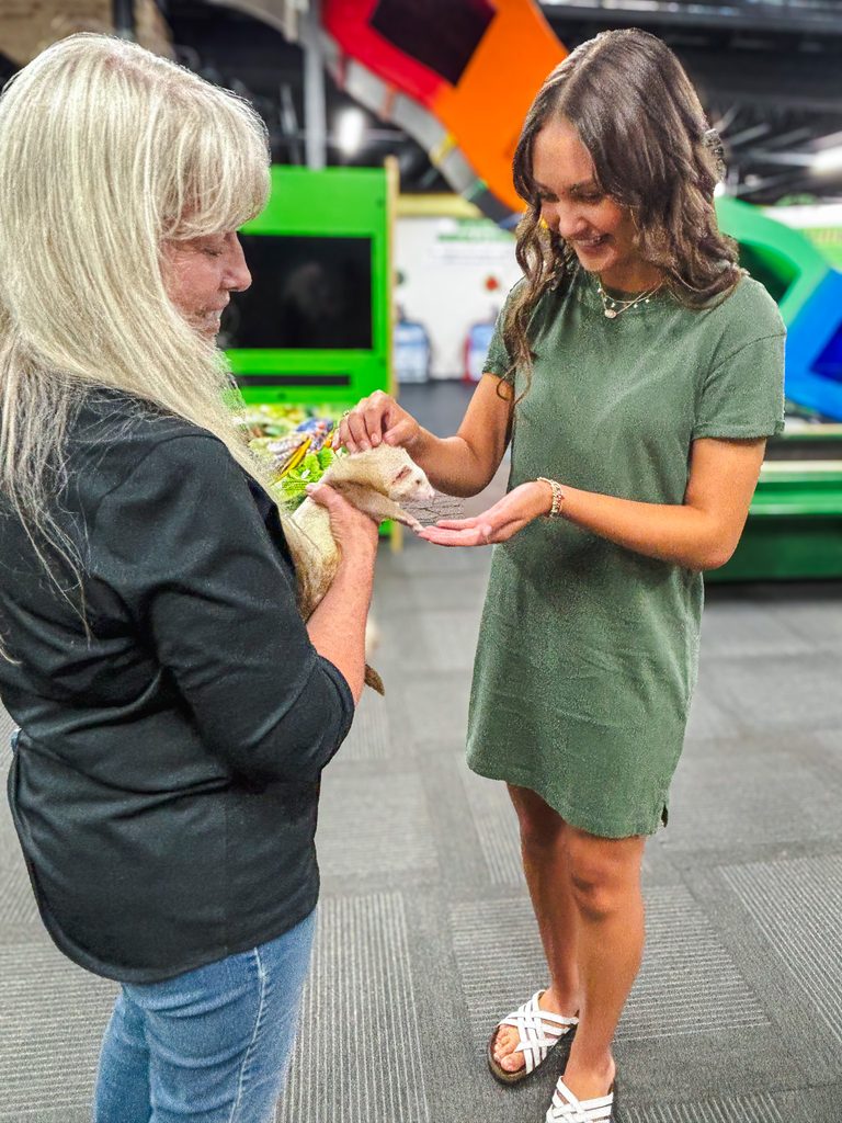In this photo, Seminole State College President’s Leadership Class XX student Mia Reich of Wright City gets an up-close introduction to a ferret held by Jasmine Moran Children’s Museum Executive Director Eileen Castle at the event.
