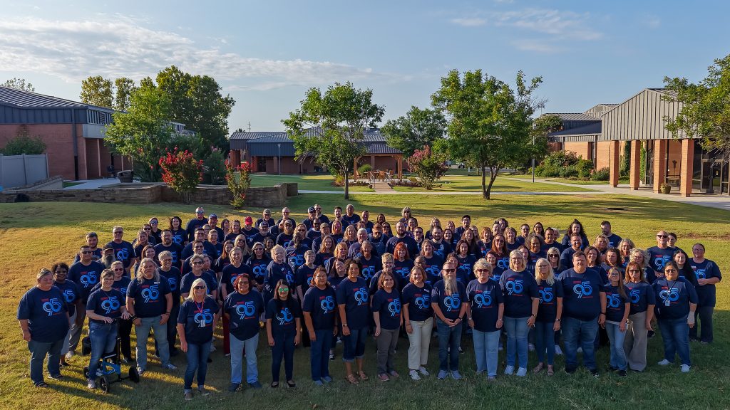 In this photo, Seminole State College’s full-time faculty and staff pose for a group photo wearing shirts commemorating the College’s 95th anniversary.