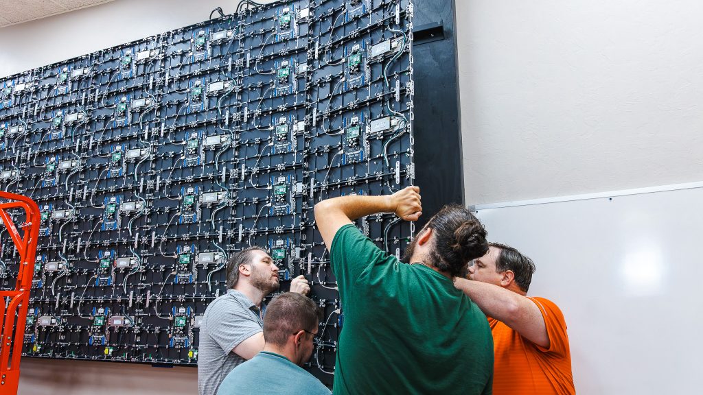 In this photo, members of SSC’s Information Technology team install a new LED video wall in a classroom in the Milt Phillips Building.