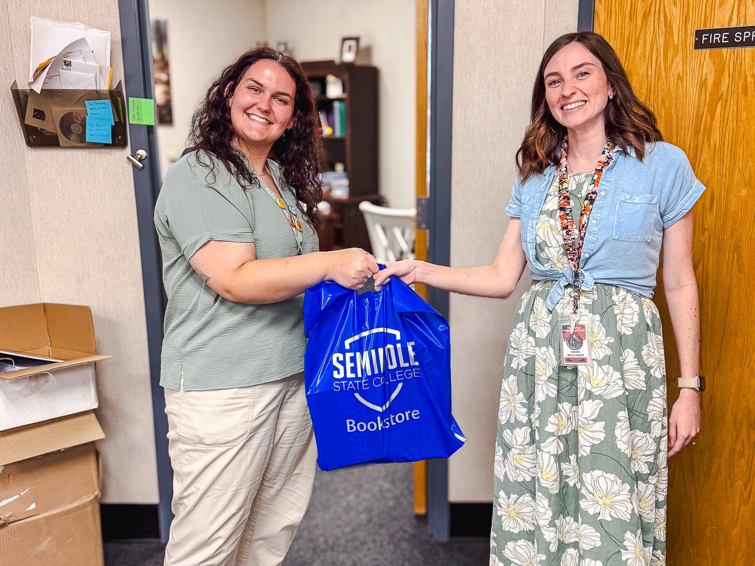 In this photo, SSC GEAR UP Lead Coordinator Leah Martin (left) delivers textbooks to Wetumka High School Counselor Randi Bellinger.