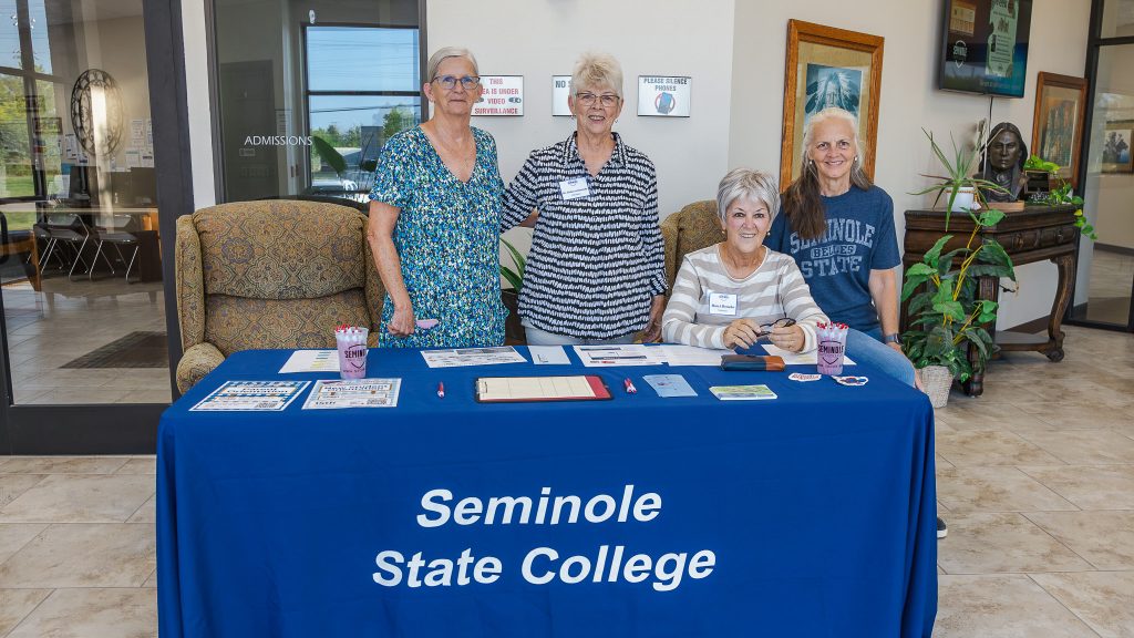 In this photo, pictured from left, former Math Professor Annette Troglin Barnes, Vice President for Academic Affairs Emeritus Dr. Rebecca Kennedy, former Regent Marci Donaho and Vice President for Academic Affairs Emeritus Dr. Linda Goeller pose for a photo as they volunteer at the Walkingstick Student Services Center, greeting students and helping connect them with assistance.