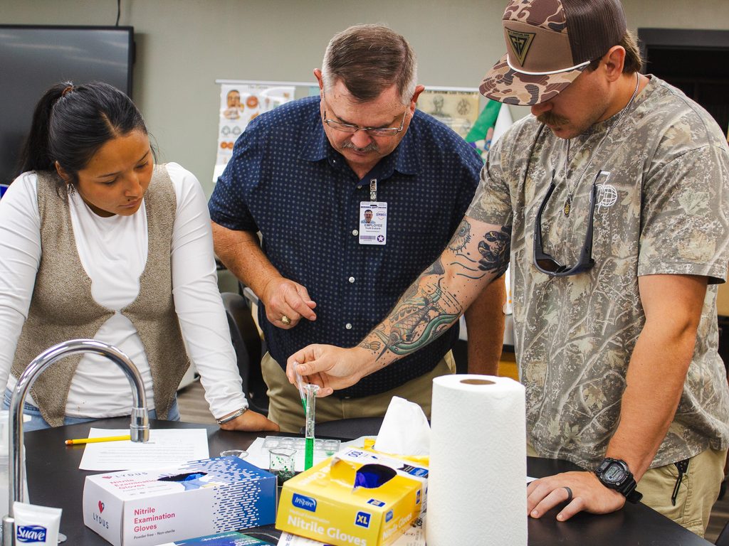 In this photo, Assistant Professor of Life Sciences Truitt Eubank, center, assists SSC students Alivia Wapskineh of McCloud, left, and Christian Herlehy of Shawnee during an Introduction to Environmental Science lab.