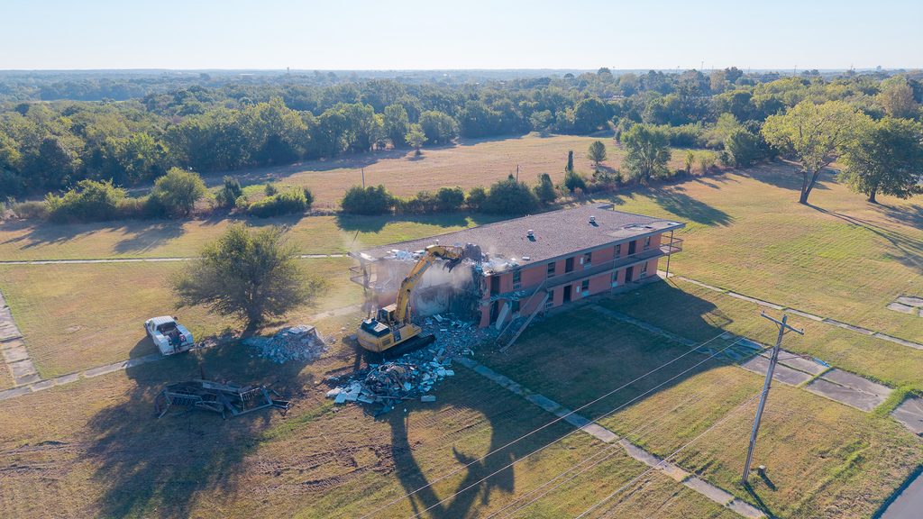 In this photo, an ariel view shows a track hoe as it tears down the former S. J. Sarkeys Dormitory on the east side of the Seminole State College campus.