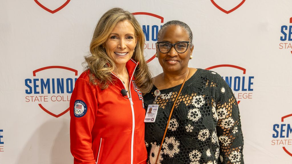 In this photo, Shannon Miller poses for a photo in front of a Seminole State College banner with SSC NASNTI Program Director Kay Wallace.