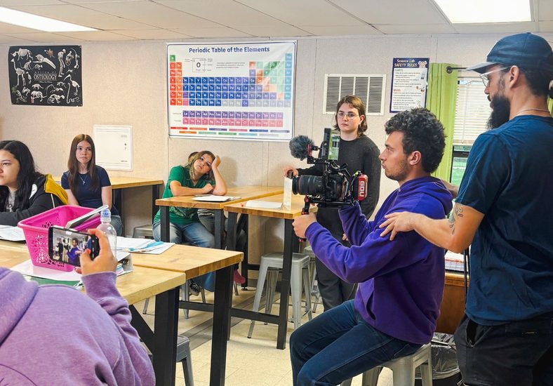In this photo, AJ Cutler, IT administrator for The Academies of Oklahoma, assists student Gabe Jones with operating a camera during production of the short film “Stay Awake.” Actors Jaxon Davis, Krislee Tobey, Olivia Bennight and Mia Clark are pictured in the background.