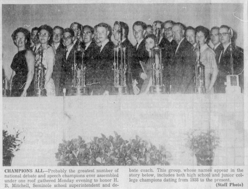 H.B. Mitchell's former students celebrate with him on stage after he was named the nation's most outstanding debate coach by the National Forensics League in 1963.